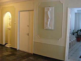 Interior hallway of Clinic Tsope in Tbilisi, with classical plasterwork and a sculpture relief